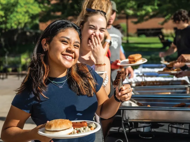 A student in line for food at and outside buffet